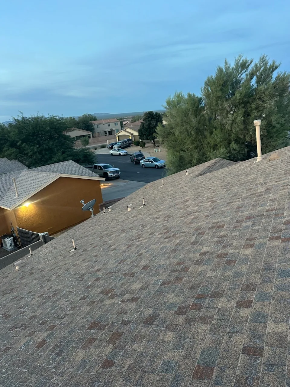 An old shingle roof before replacement, photographed at dusk