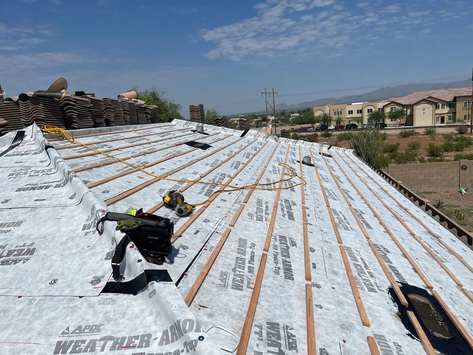 New underlayment with raised battens across a whole roof, tile stacked at the ridge